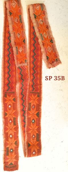 A hand embroidered strip with mirrors of sandstone red coloured cotton.