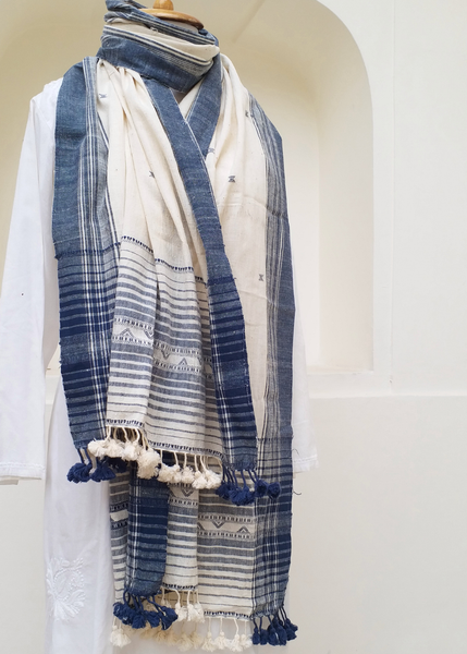 Blue and white patterned scarf with tassels on a mannequin against a white background