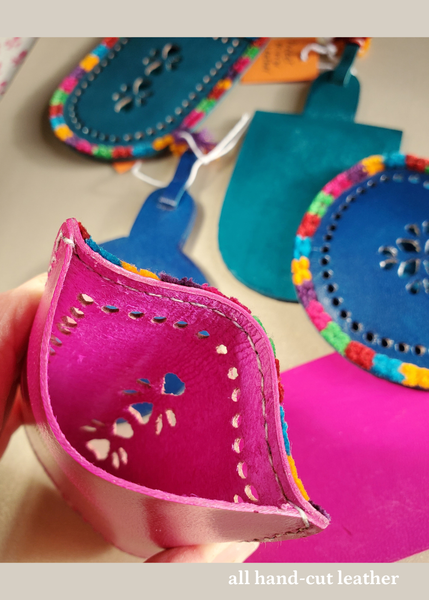 hand crafted bright pink hand-cut leather pocket mirrors with decorative perforations