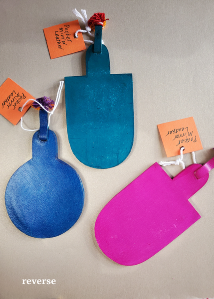 hand crafted hand-cut leather pocket mirrors with decorative perforations