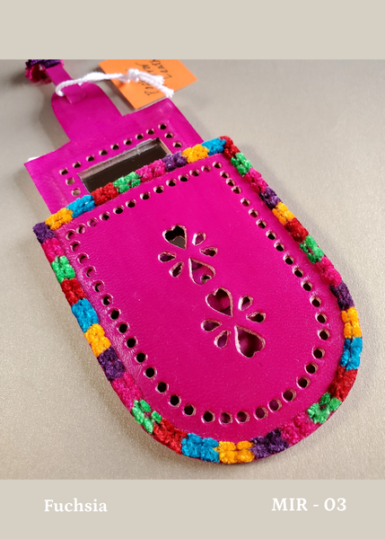 hand crafted pocket mirror fitted into it's own real leather case with decorative perforations. Bright fuchsia pink
