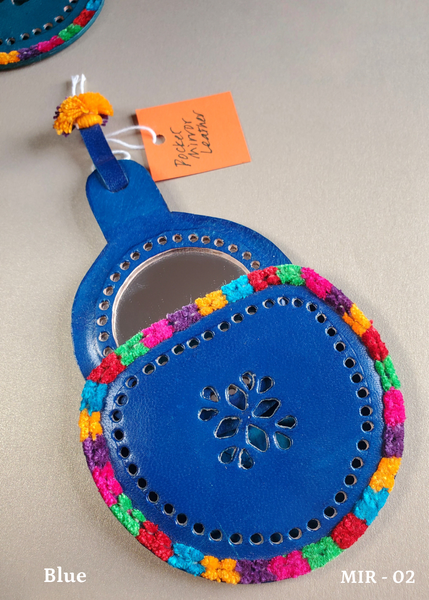 hand crafted bright blue hand-cut leather pocket mirror with decorative perforations