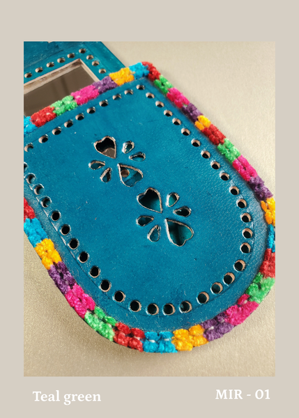 hand crafted bright teal green hand-cut leather pocket mirror with decorative perforations