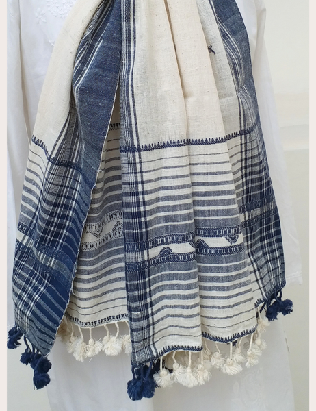 Blue and white striped towel with tassels on a white background