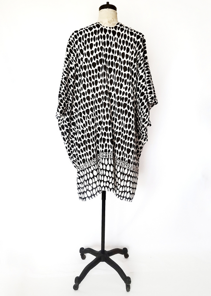 Playa kimono with two versions of butti print. White with black on top and at the waist it changes to black with white print. Short sleeves, slit on side.
