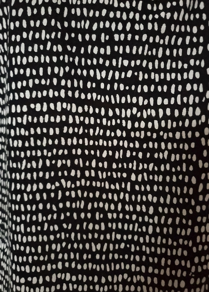 Close up of dhana print. Black with white speckles.