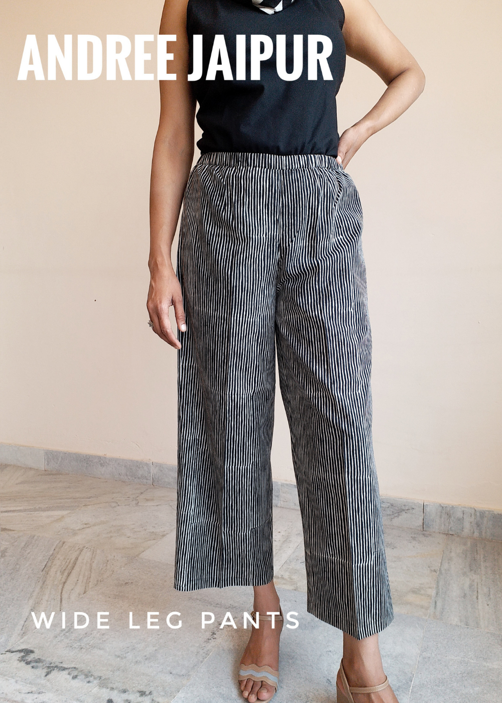 Matchstick pant with cinched waist and wide leg shown with black tank top.