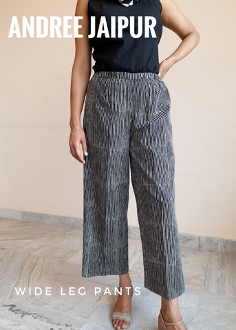 Matchstick pant with cinched waist and wide leg shown with black tank top.