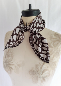 Butti print scarf tied on mannequin.