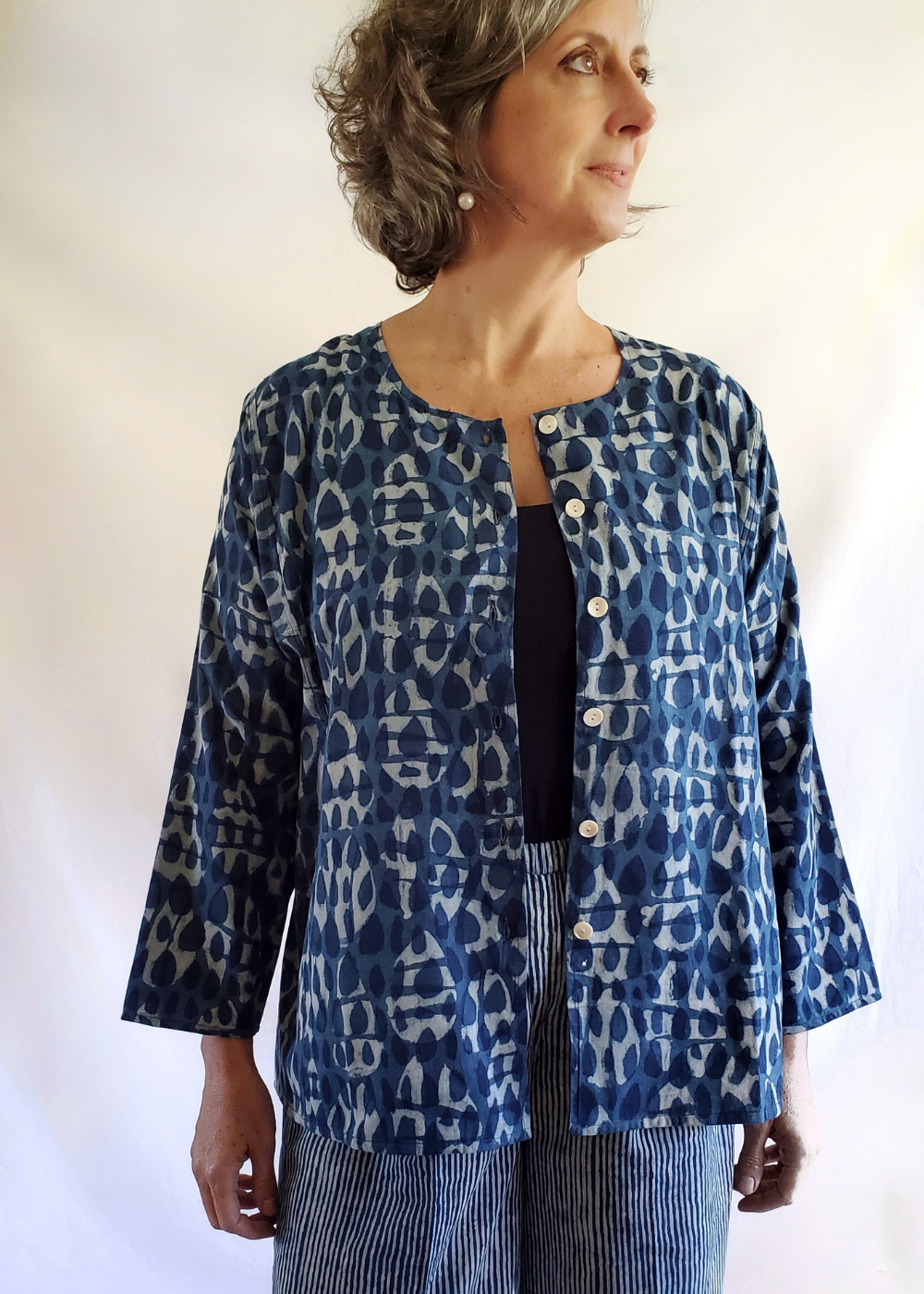 Model wearing Six Button Blouse, Unbuttoned in Indigo Basalt Pattern.