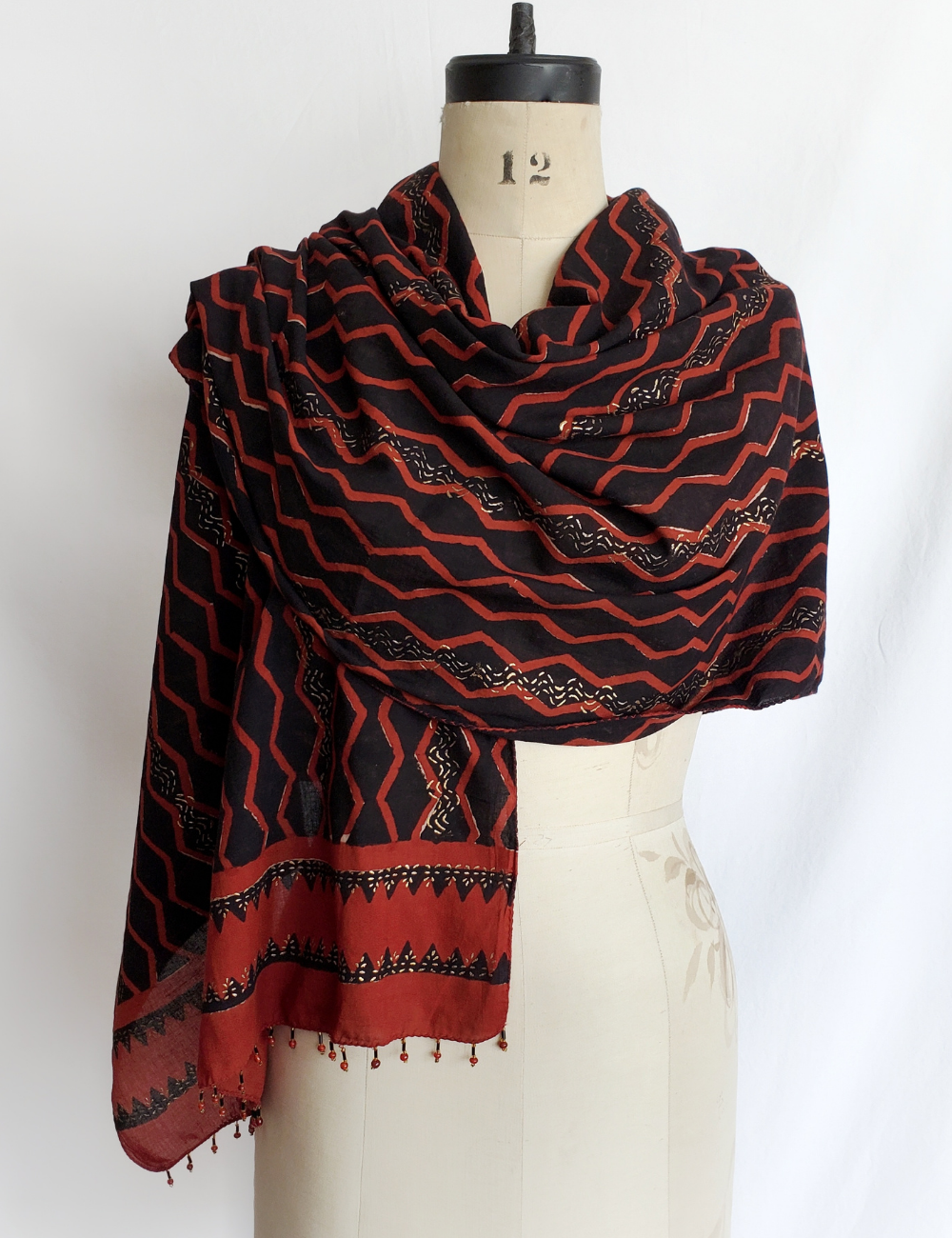 Rusty red and black long scarf with gold detailing.