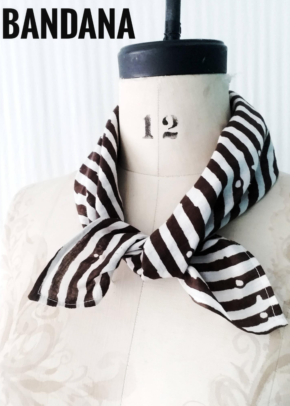 Black and White Danda Scarf tied around mannequin. Striped pattern.