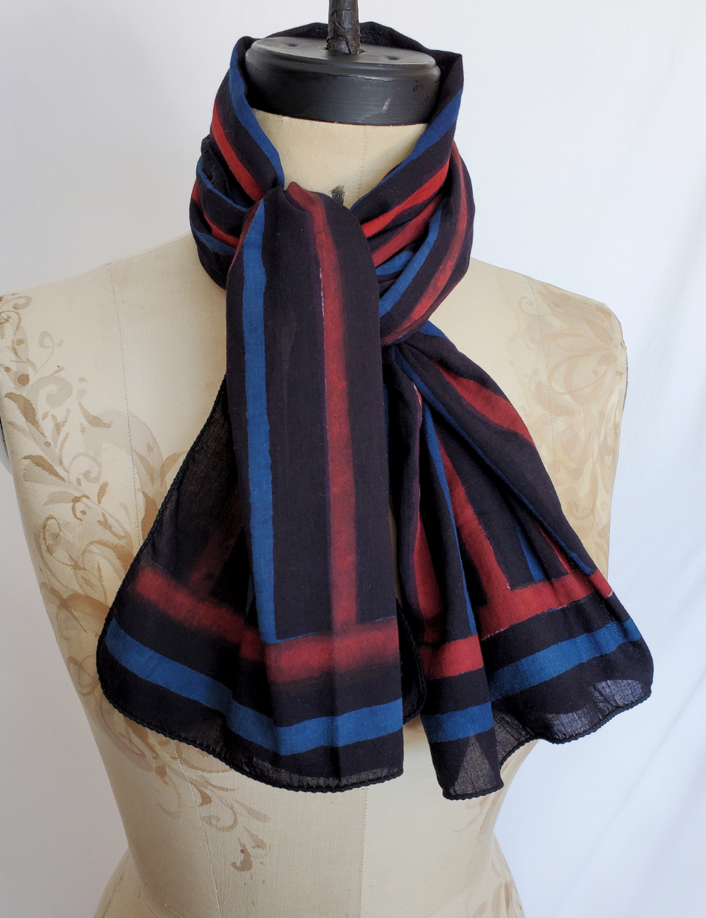 Blue, red and black striped hand block print scarf. The black stripe is the thickest and most prominent.