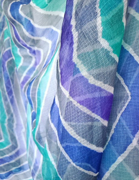 Scarf that is gray with vibrant Iris blue, Violet and Aqua bands.