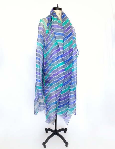 Scarf that is gray with vibrant Iris blue, Violet and Aqua bands.