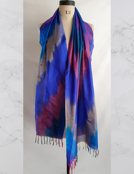 Rainbow hued scarf with tassles.