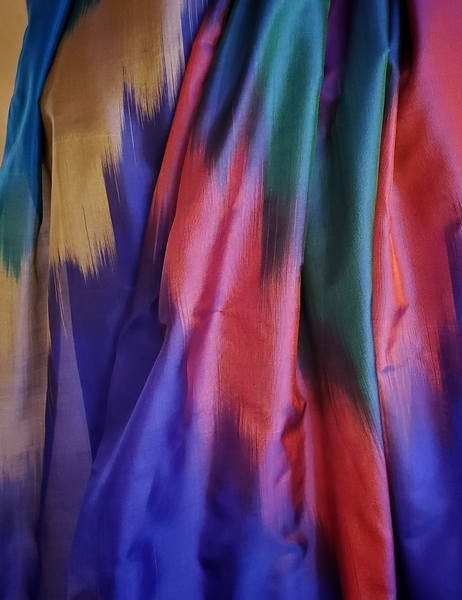 Rainbow hued scarf with tassles.