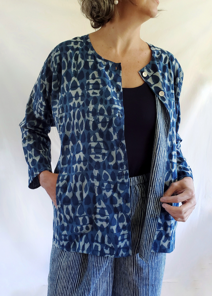 Model wearing Six Button Blouse unbuttoned, in Indigo Basalt Pattern. Inside is Blue Striped and can be worn inside out.
