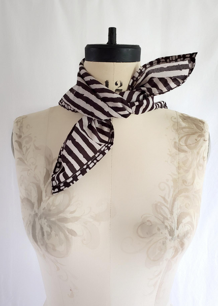 Stripe scarf tied on mannequin.
